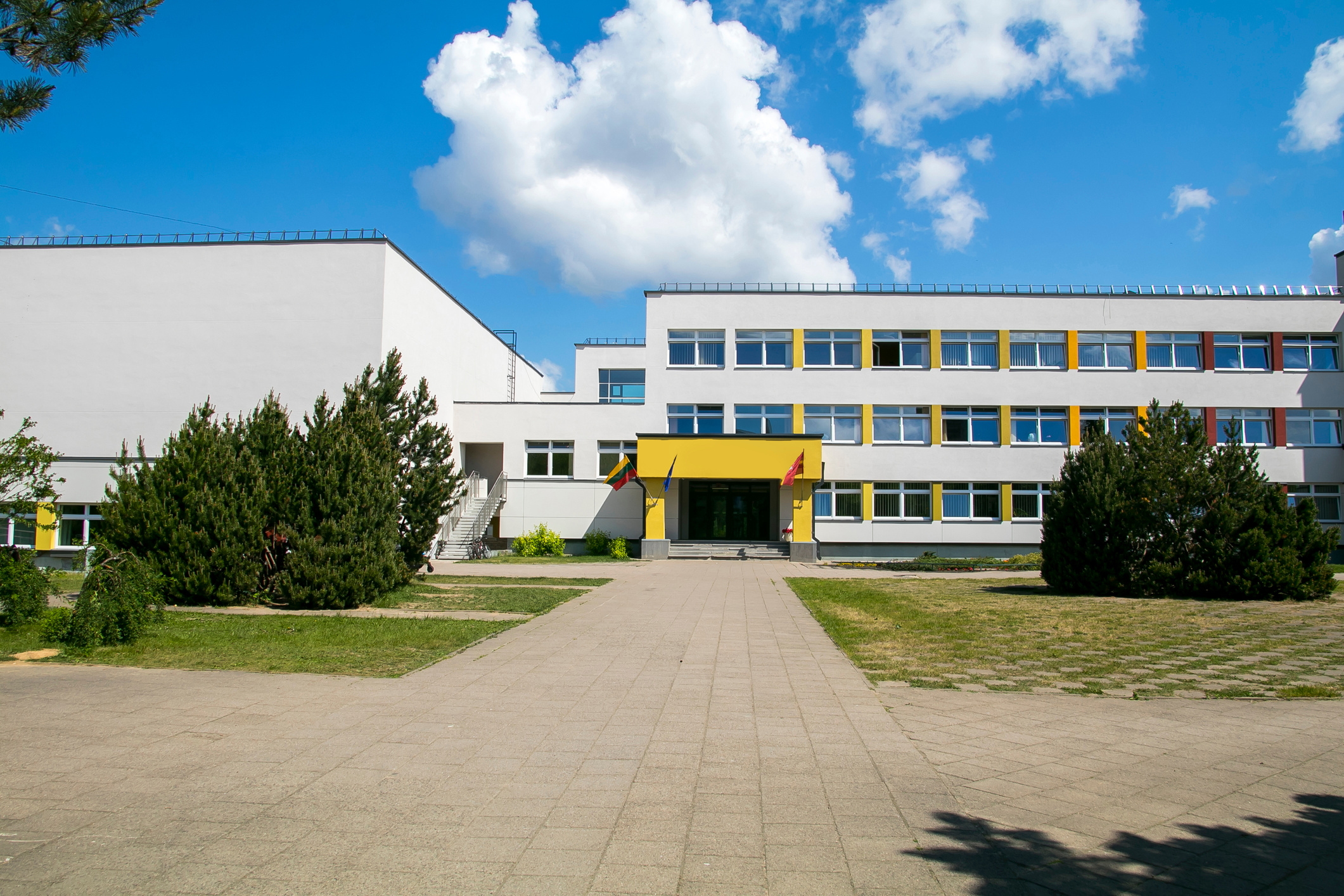Public school building. Exterior view of school building with playground
